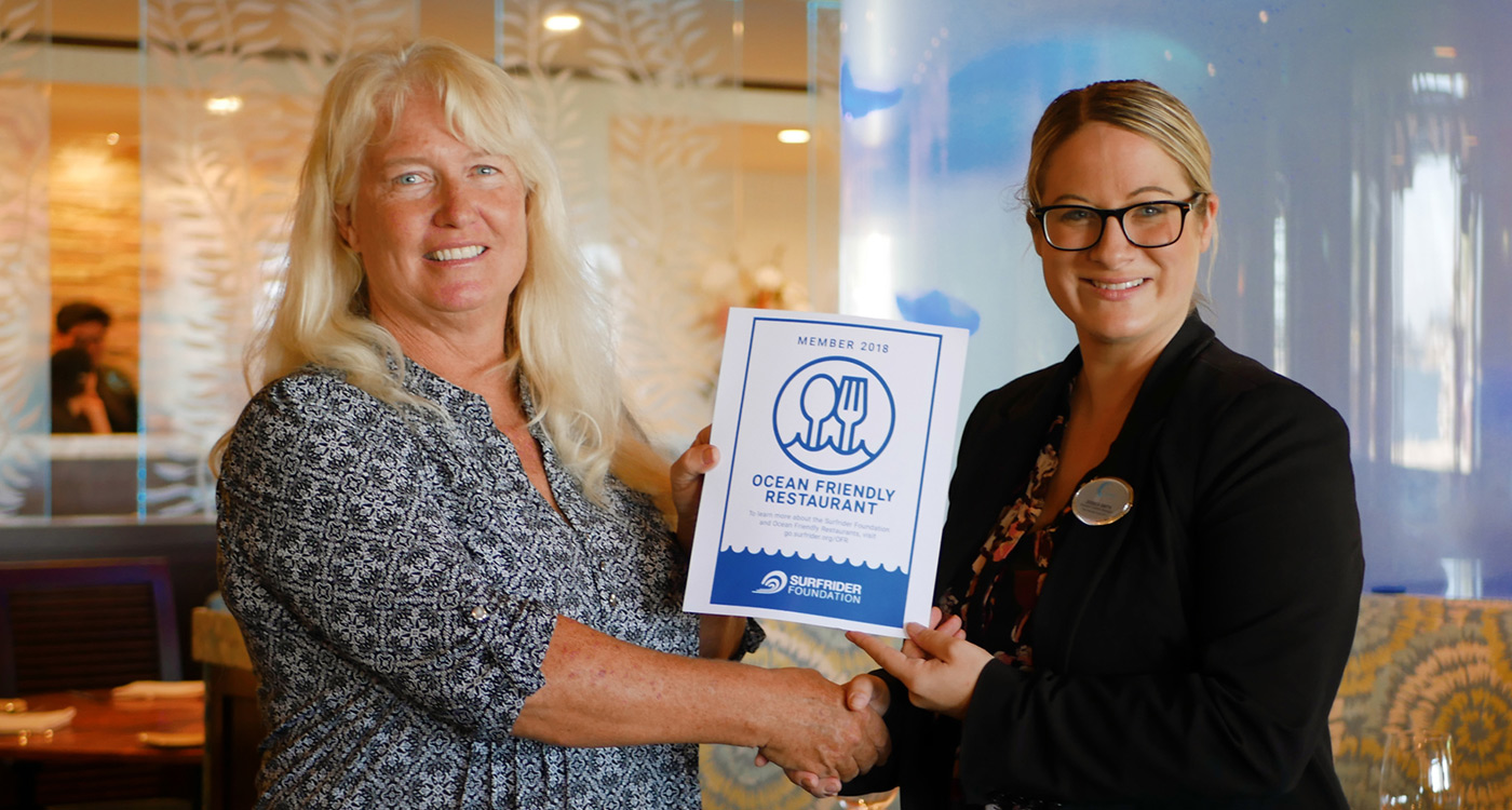 Evans Hotels' employee being presented by the Surfrider Foundation with the Ocean Friendly certification.