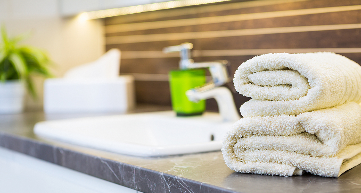 Towels on the counter at an Evans Hotel property where green and sustainable initiatives are implemented